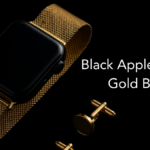 Black Apple Watch with gold mesh band and matching gold cufflinks on black background.