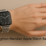 Hand wearing an Apple Watch with a silver engraved Brighton Meridian band.